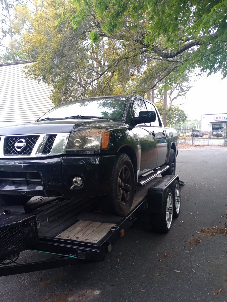 Pickup truck loaded on a towing trailer for roadside transport