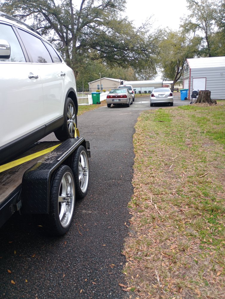SUV secured on a trailer during an emergency tow in Gainesville, FL