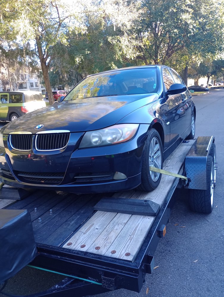 Car loaded onto a towing trailer after being moved from the scene
